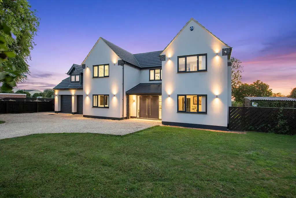Completed Ablewood new build in Graveley lit at dusk